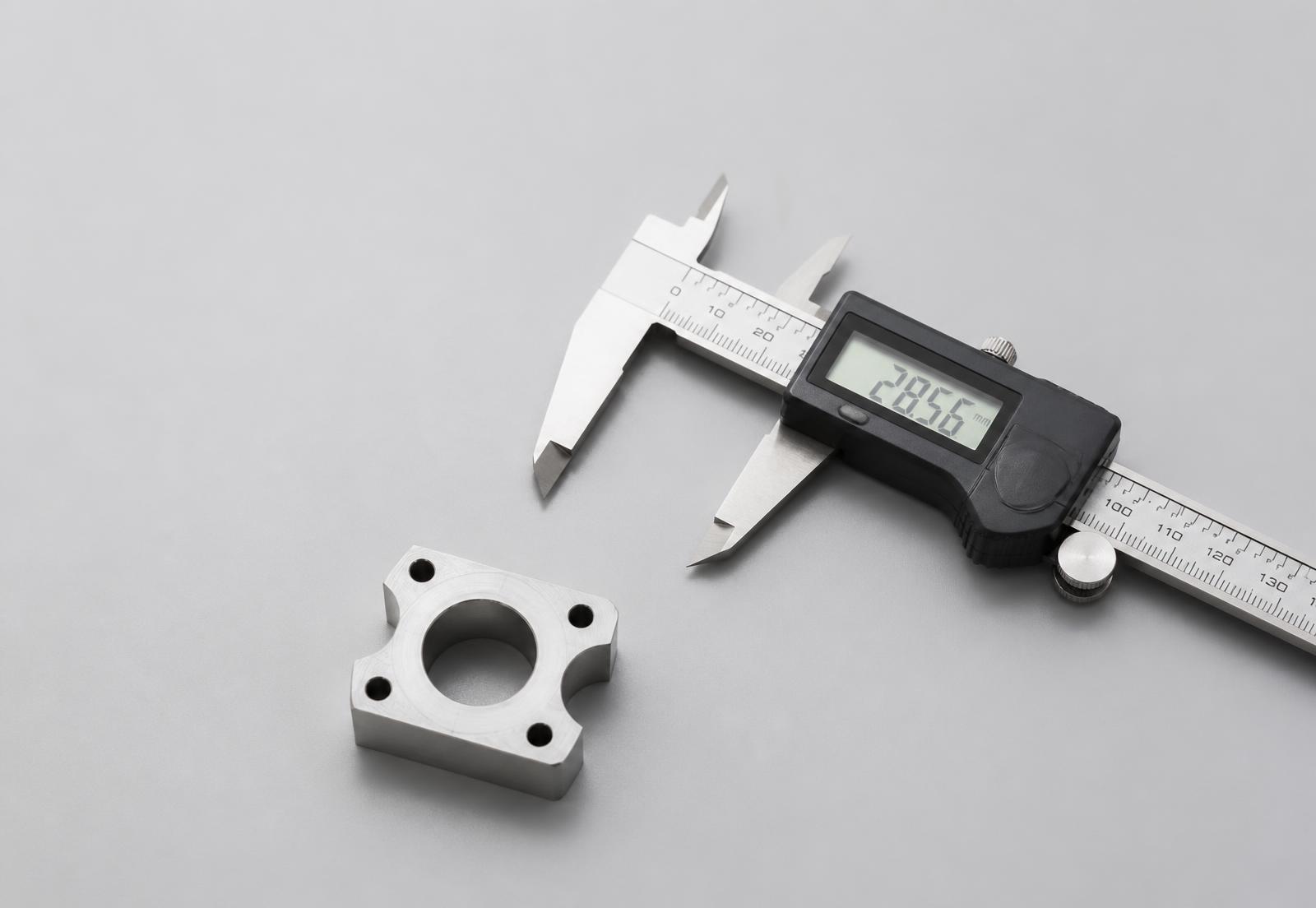 A machined component measured with a digital caliper